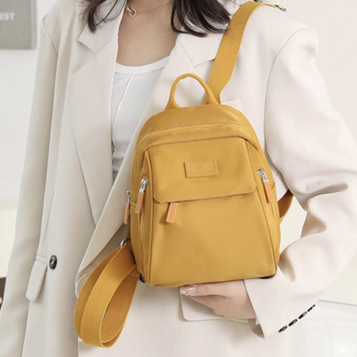 Women casual backpack by dropshipping in mustard yellow nylon with hidden storage pocket for small items