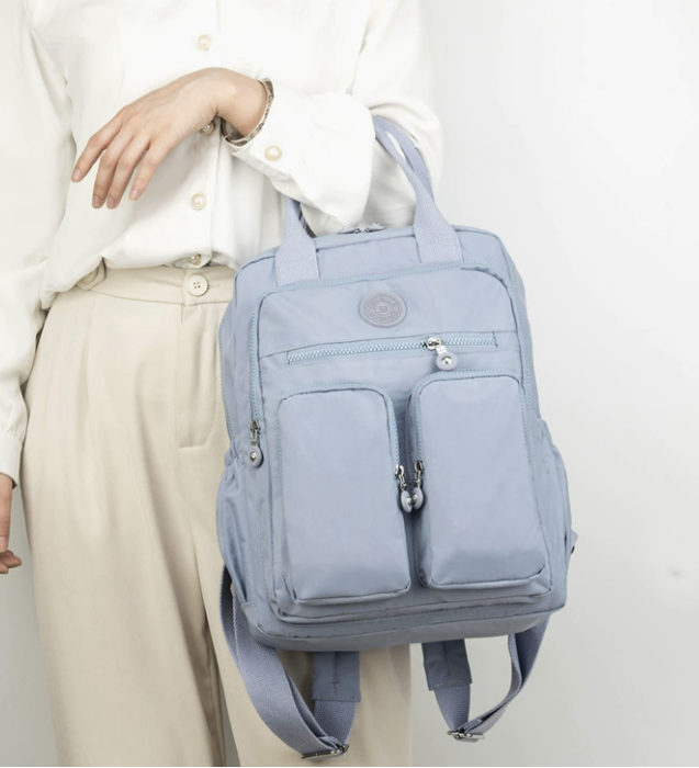 Water resistant multi purpose backpack by dropshipping in light blue nylon with hidden pocket and laptop sleeve