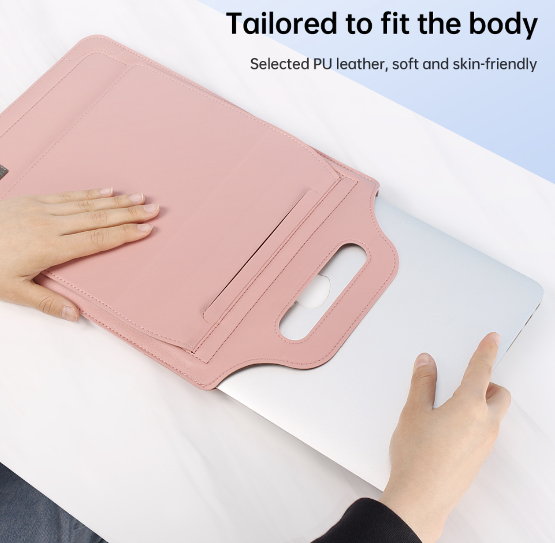 A pink laptop stand or tablet holder made of PU leather, shown being used under a silver laptop on a white desk. The image includes text overlays that read 'Tailored to fit the body' and 'Selected PU leather, soft and skin-friendly'.