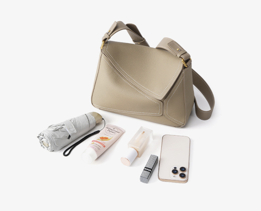 Unique crossbody bag by AB-28 in taupe faux leather with adjustable shoulder strap and multiple pockets