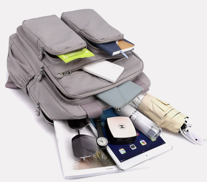 Water resistant multi purpose backpack dropshipping in gray nylon with multiple pockets and a hidden compartment