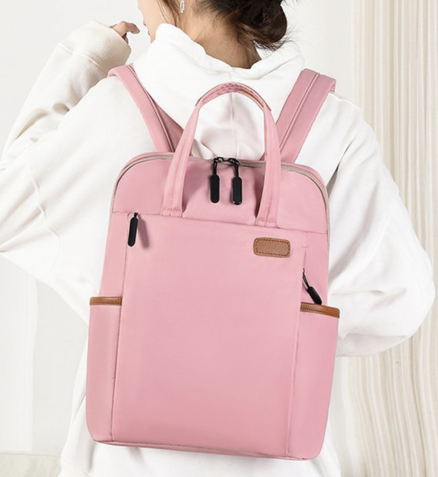 Women laptop backpack by dropshipping in soft pink with padded shoulder straps and a hidden pocket