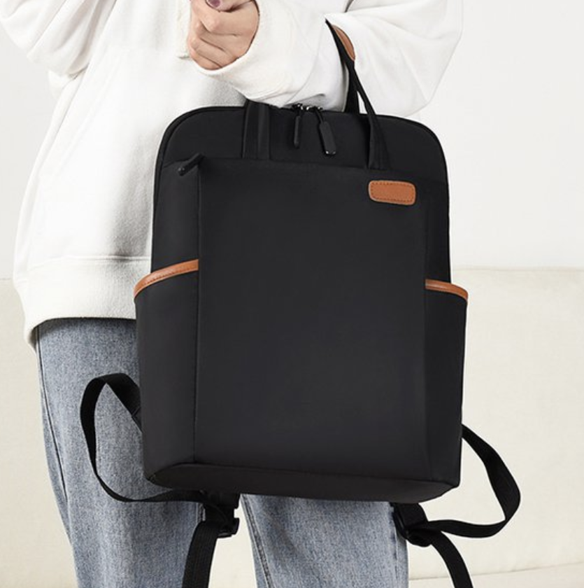 Dropshipping women laptop backpack in black with padded shoulder straps and a hidden pocket, shown on a model
