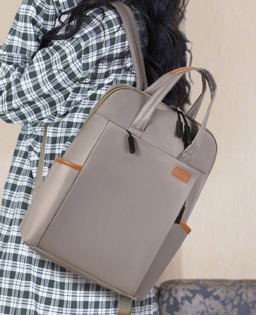 Dropshipping womens laptop backpack in light gray with padded shoulder straps and a hidden pocket